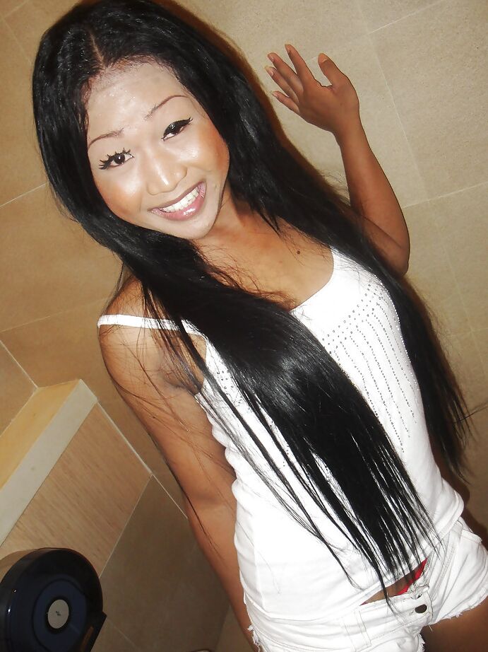 16P Cute small tit Thai ladyboy Kem posing in high heels and stroking her cock