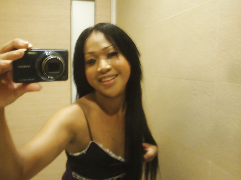 16P Cute small tit Thai ladyboy Kem posing in high heels and stroking her cock