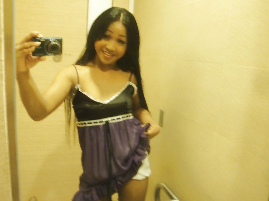 16P Cute small tit Thai ladyboy Kem posing in high heels and stroking her cock