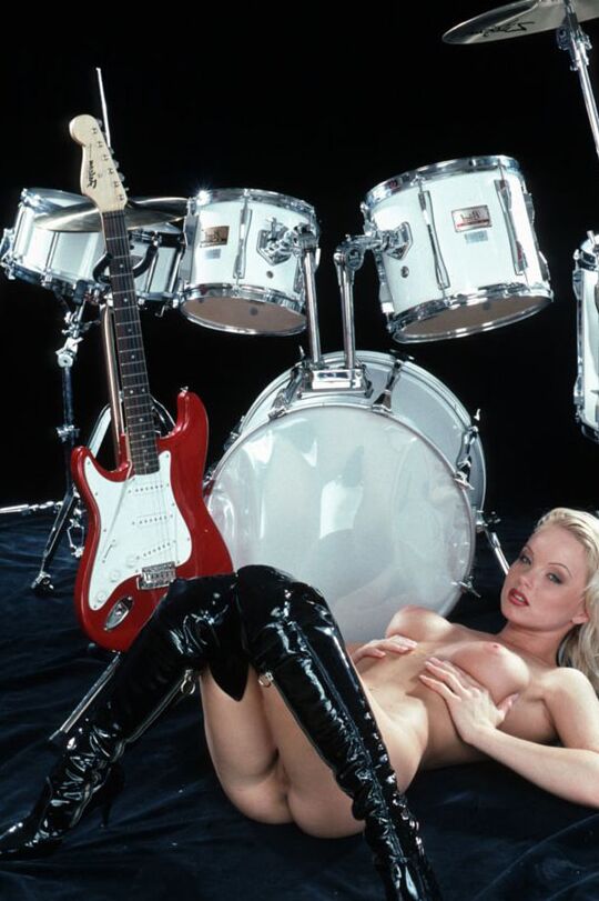 10P Hot blonde naked except for shiny black latex high heel boots enjoys playing
