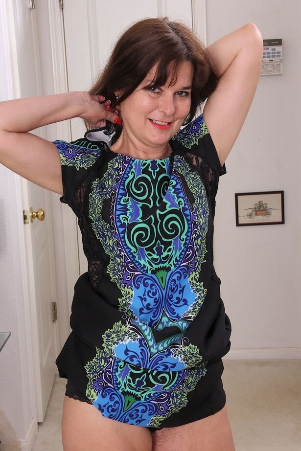 16P Middle aged broad Bridget Calling strips naked in hallway to display her bush