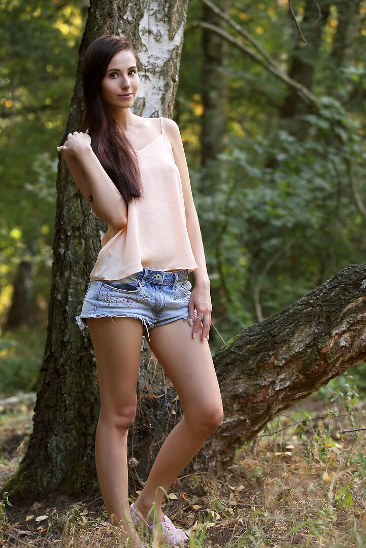 12P Chica guapa de pelo largo libera su coño de mariposa de los pantalones cortos en el bosque