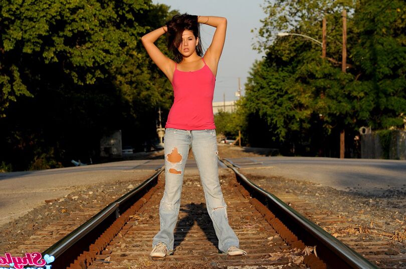 12P Amateur model Shyla Jennings unbuttons her ripped jeans on railway tracks