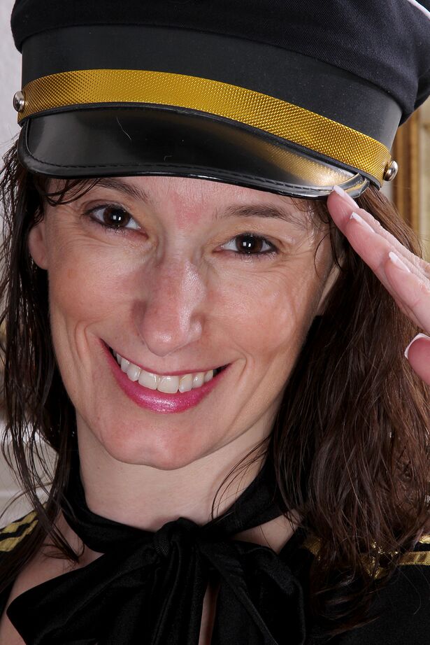 16P 30 plus woman Celeste Carpenter doffs her pilot's uniform to model in the nude