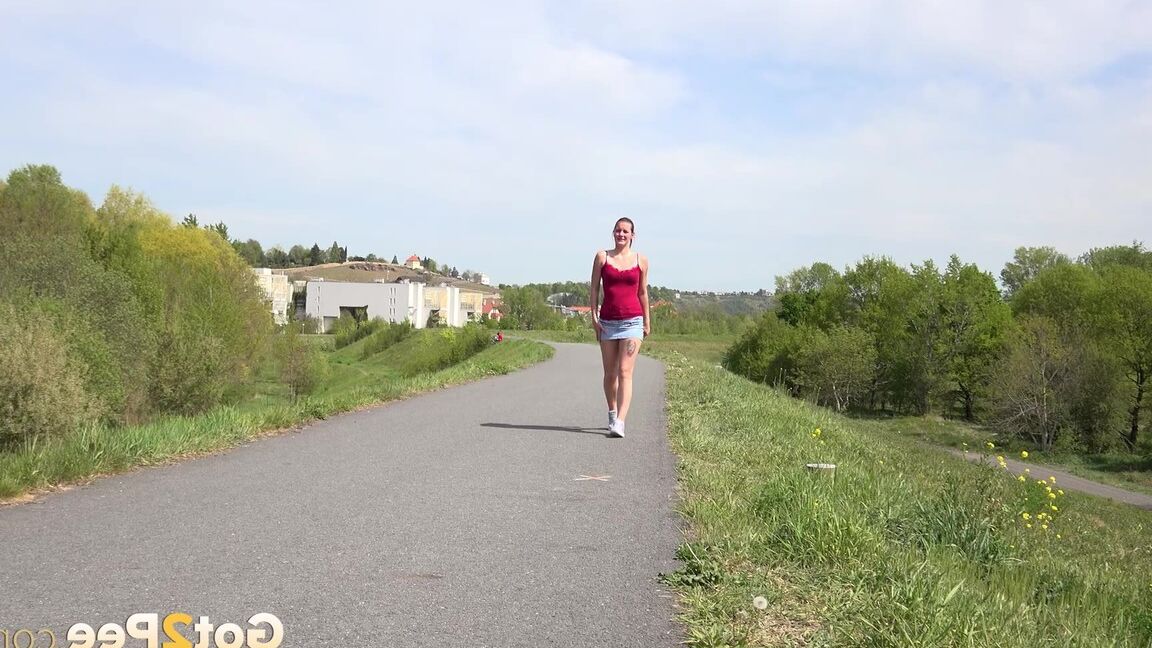 15P Caucasian girl Amanda Hill pisses on a paved roadway while out for a jog