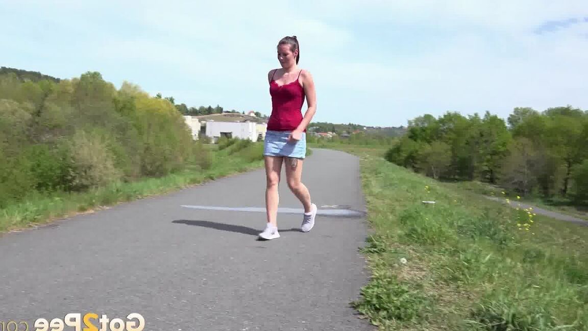 15P Caucasian girl Amanda Hill pisses on a paved roadway while out for a jog