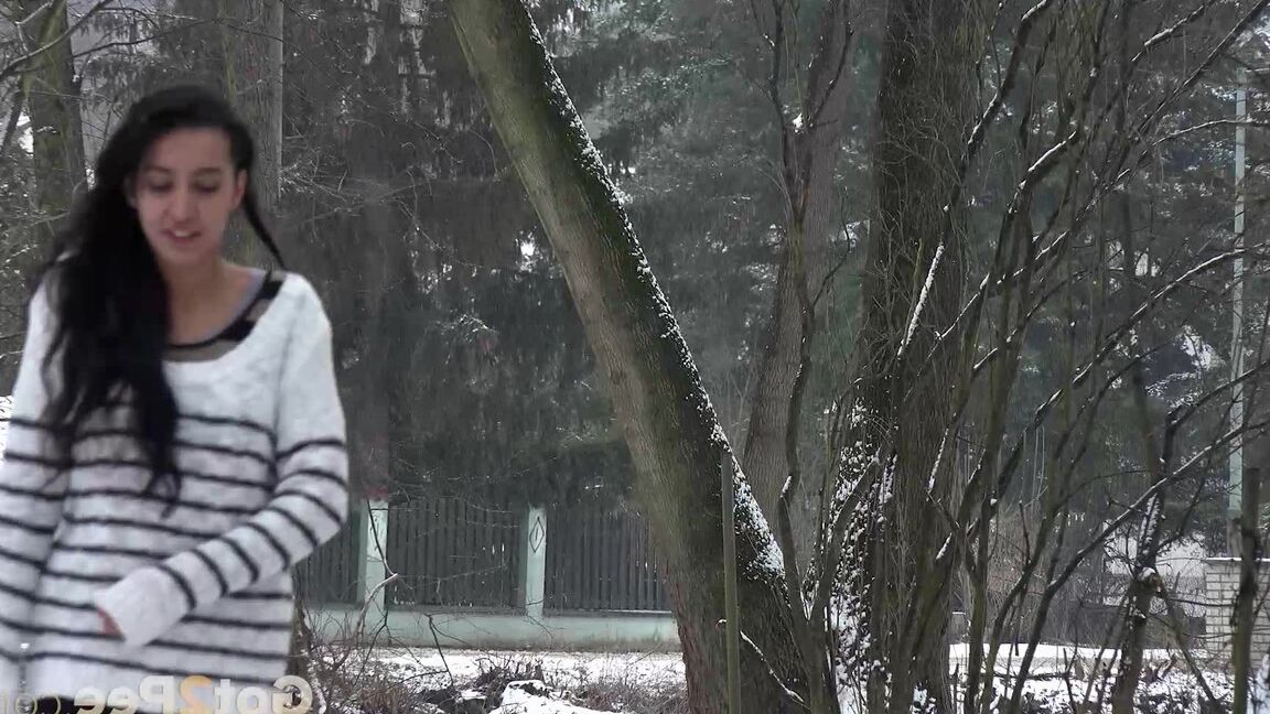 15P Pretty dark haired babe pisses outside in the snow