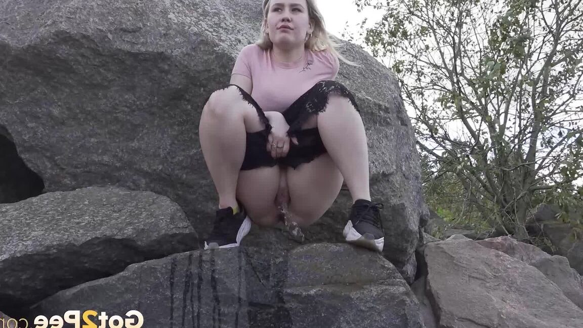 15P Une blonde chaude baisse son short pour pisser sur des rochers