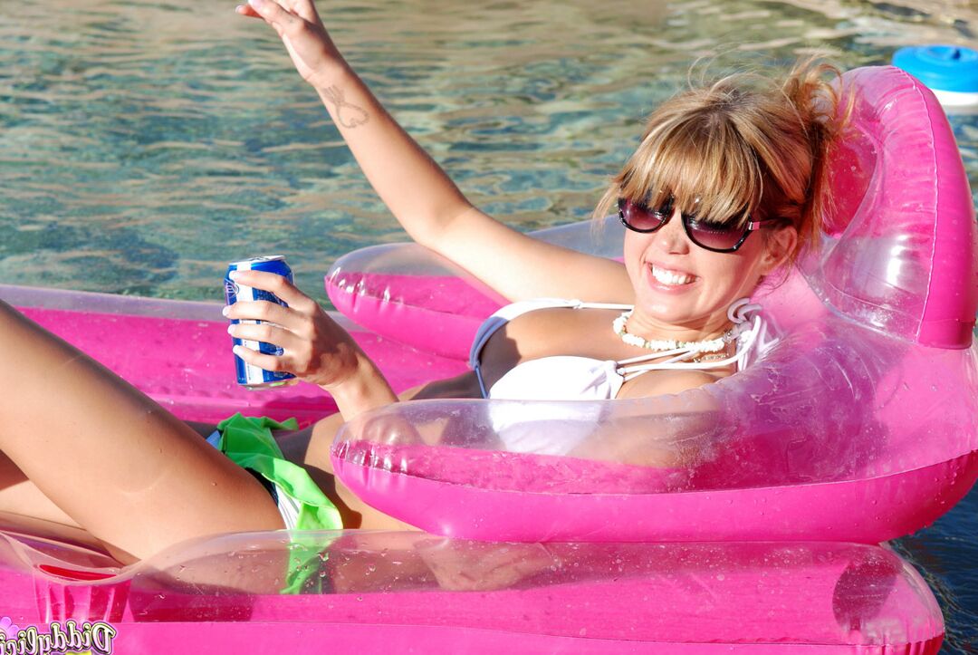 12P Young amateur Diddylicious takes off her bikini while in a swimming pool