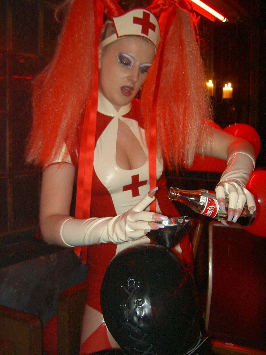 16P Latex attired nurse Joanne Lafontaine uses Darkwing Zero as her slave