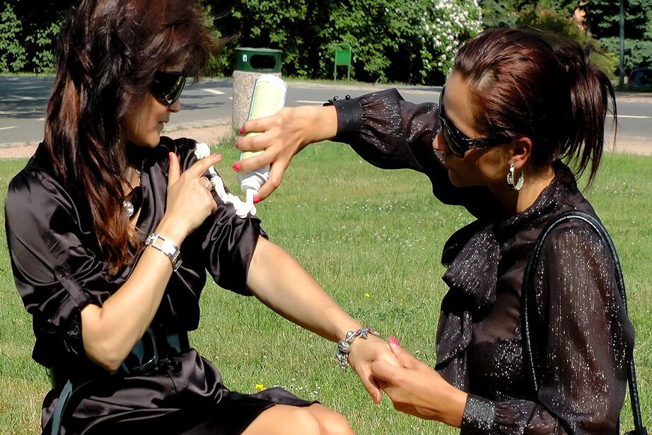 15P Two clothed females completely cover each other with whip cream in public park