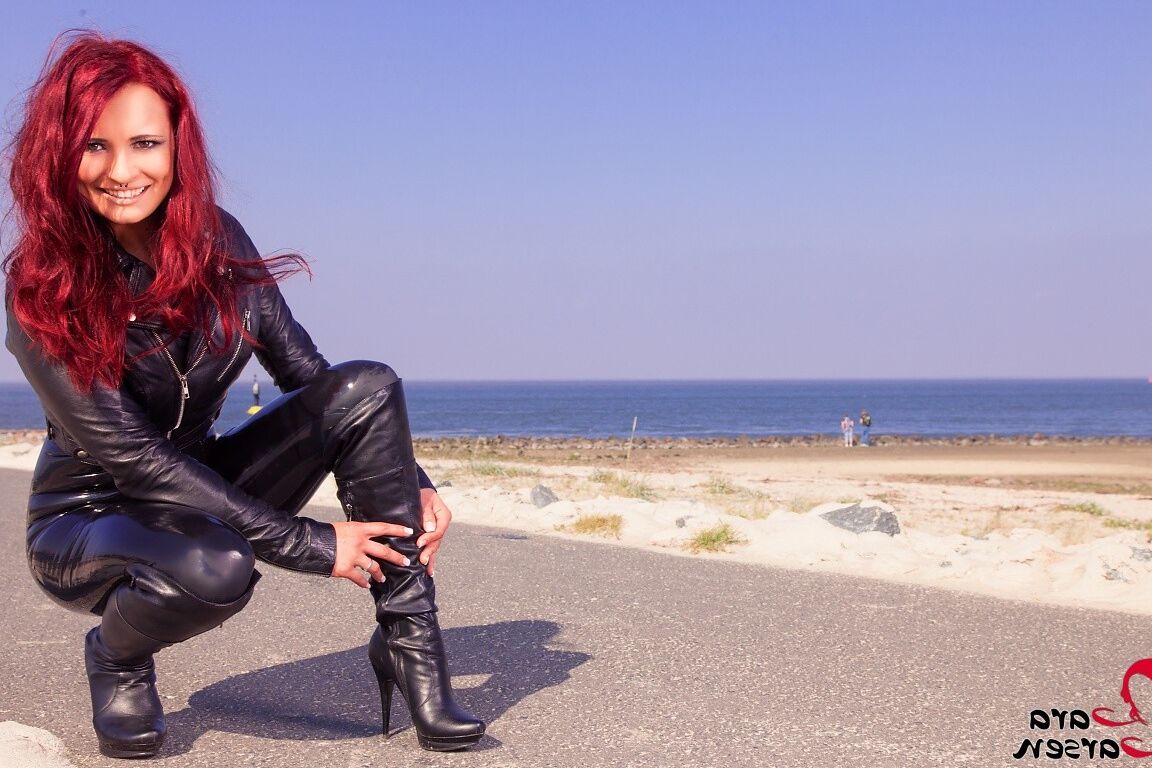 12P Redheaded model Lara Larsen poses in leather attire during a trip to Cuxhaven