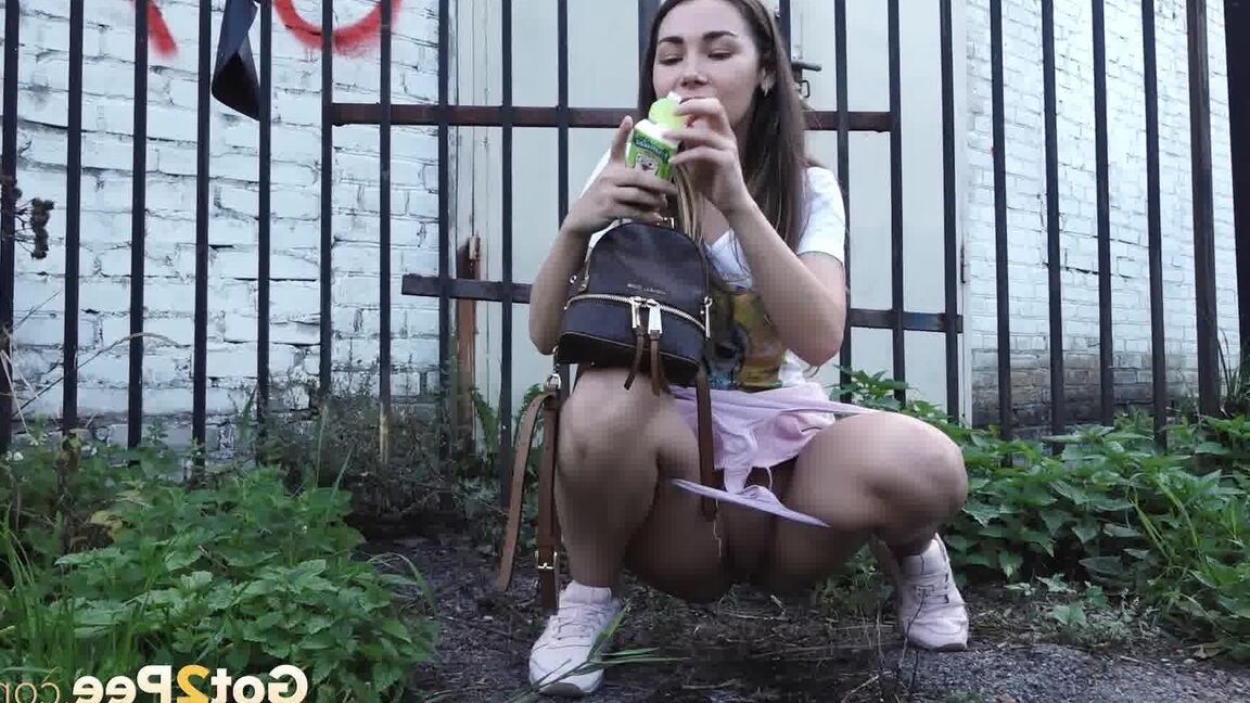 15P Distressed girl Sasha S lifts up a skirt before taking a pee behind a building