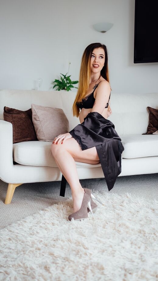 13P Pale redhead model Misha Cross crosses her legs to display her tight pussy