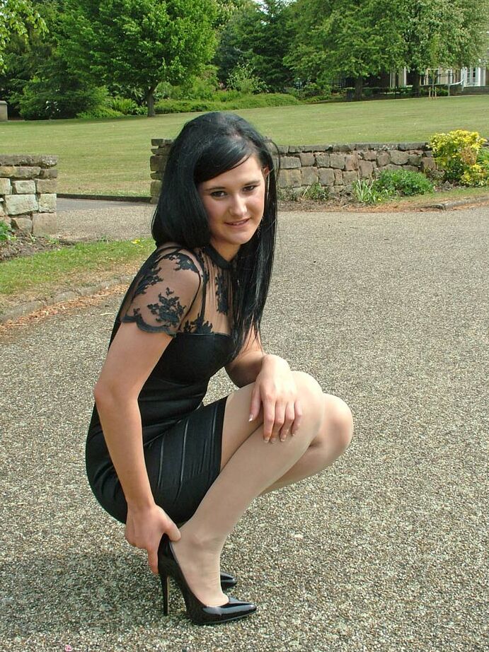 16P Clothed brunette female models her new black pumps in hosiery