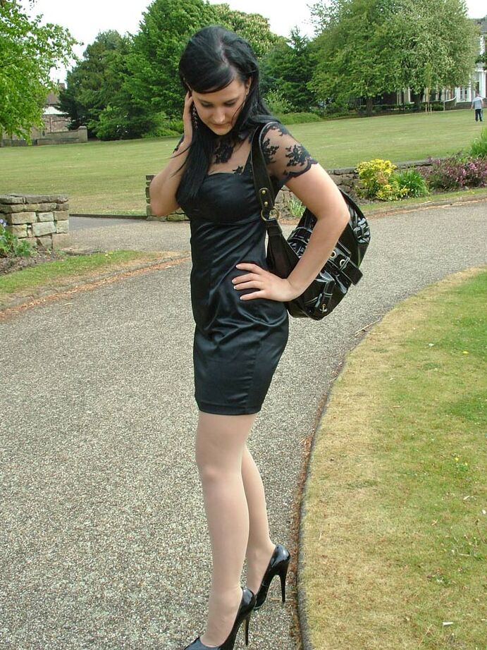 16P Clothed brunette female models her new black pumps in hosiery