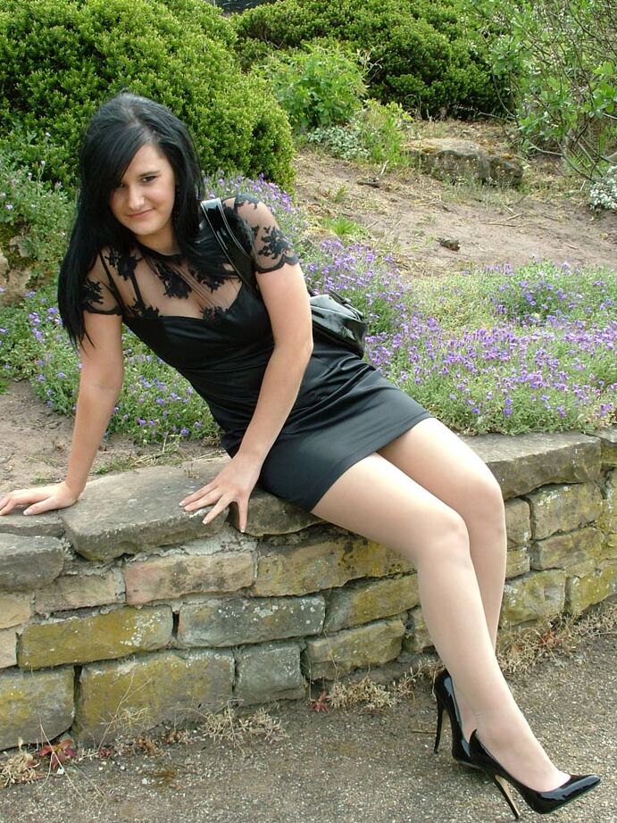 16P Clothed brunette female models her new black pumps in hosiery