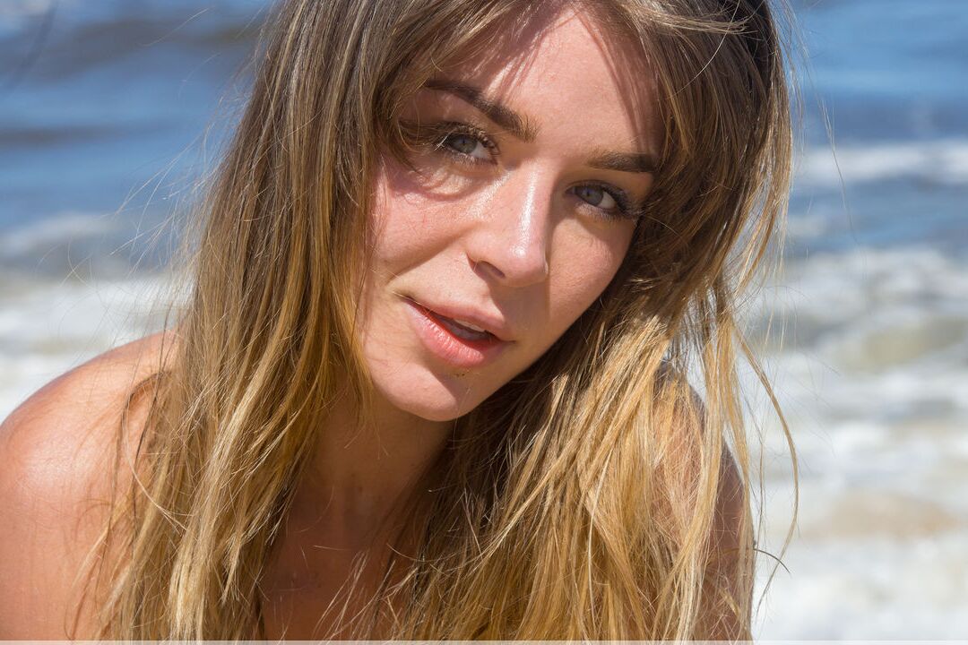 16P Nice younger Natalia E gets totally naked while on a sandy beach