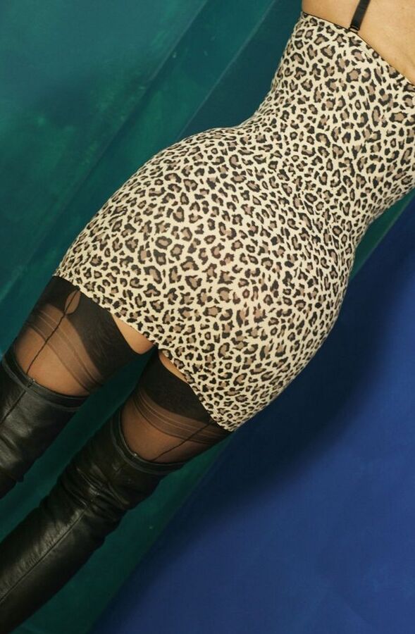 12P Mature blonde smokes a cigarette while exposing satin panties in OTK boots