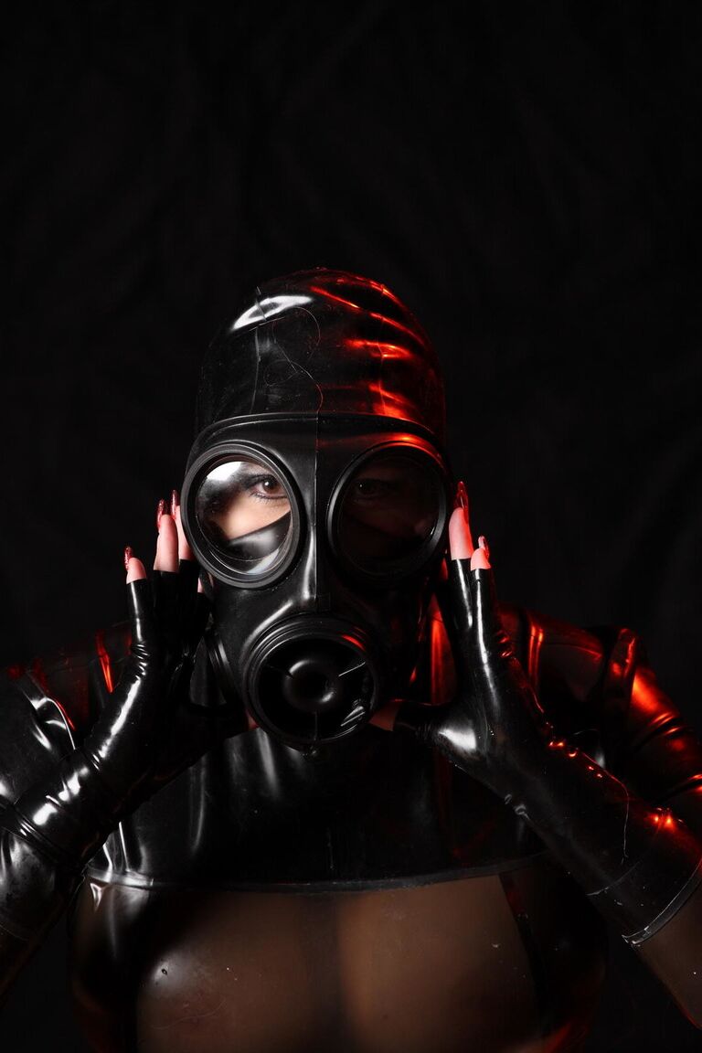 16P Solo model Avengelique poses in latex clothing and a gas mask