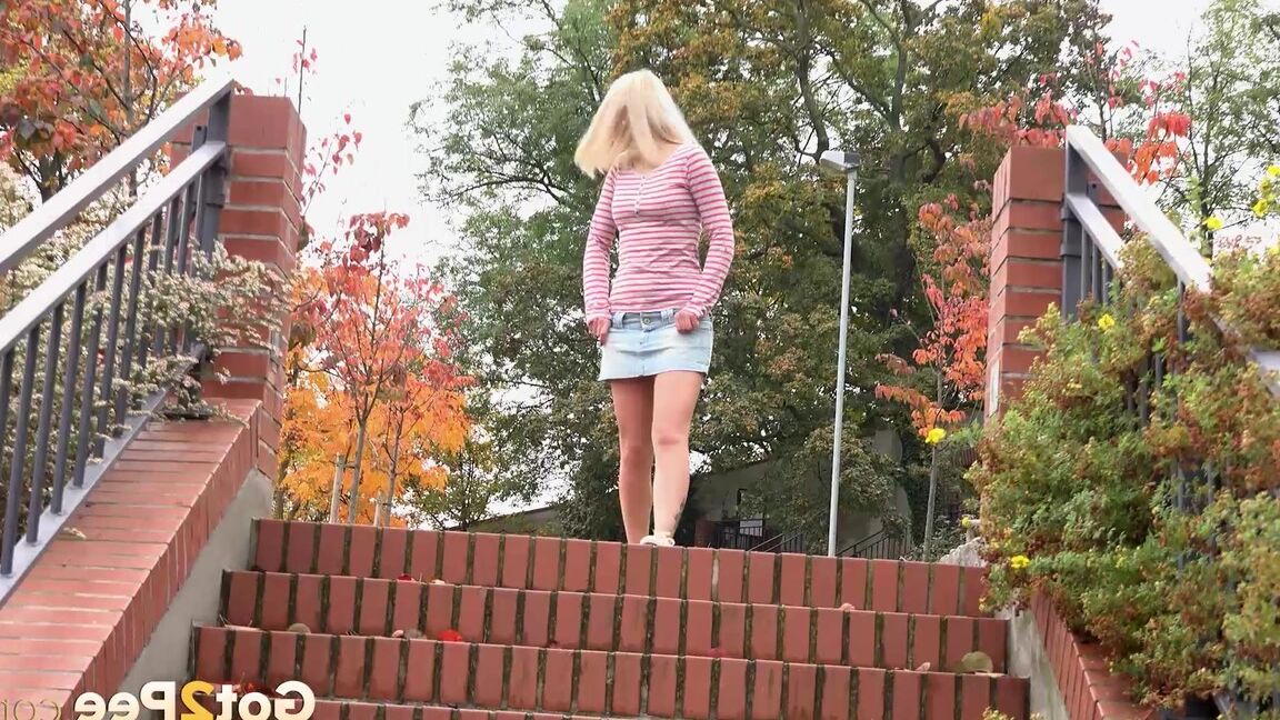 15P Blonde teen Debora pulls aside cotton panties to pee on the steps in public