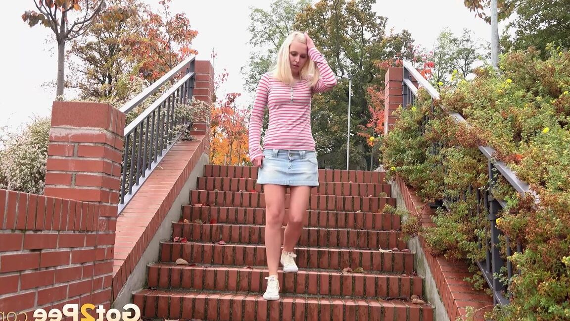 15P Blonde teen Debora pulls aside cotton panties to pee on the steps in public