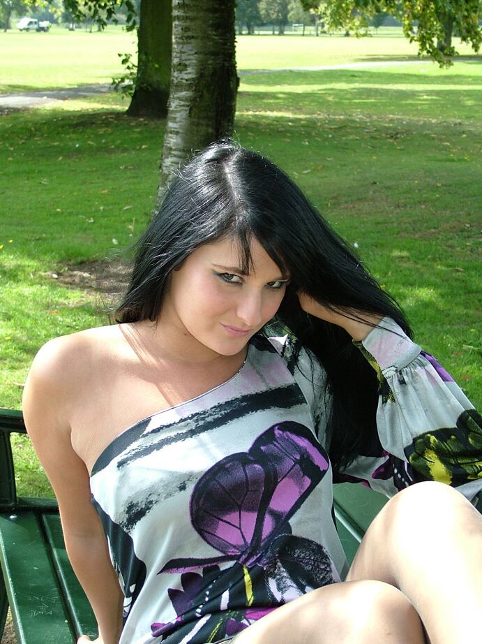 16P Dark haired girl flashes stocking tops while adjusting her pumps on a bench