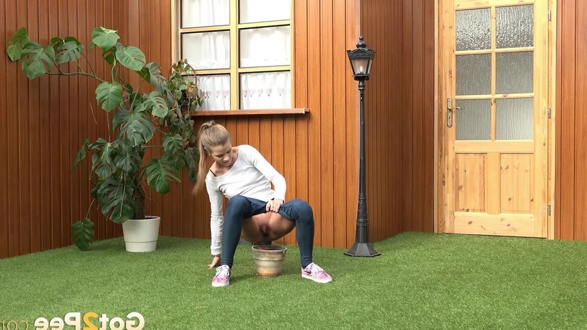 15P Blonde girl Sarah Key pulls down tight jeans to pee in a flower pot
