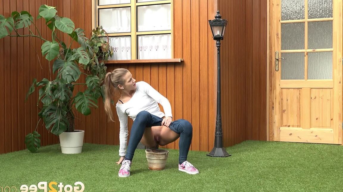 15P Blonde girl Sarah Key pulls down tight jeans to pee in a flower pot
