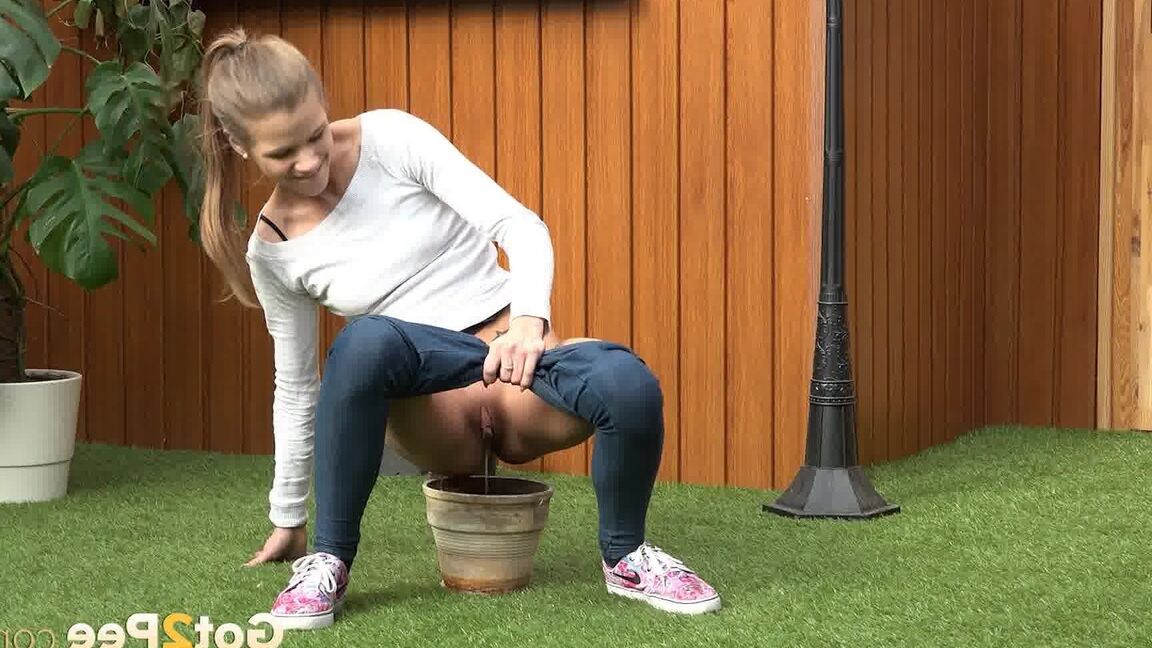 15P Blonde girl Sarah Key pulls down tight jeans to pee in a flower pot