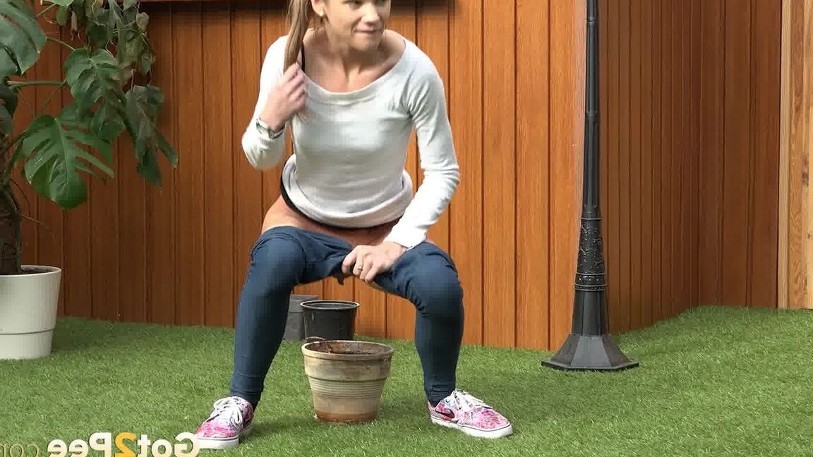 15P Blonde girl Sarah Key pulls down tight jeans to pee in a flower pot
