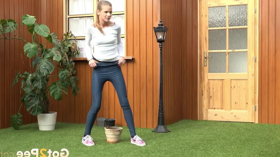 15P Blonde girl Sarah Key pulls down tight jeans to pee in a flower pot