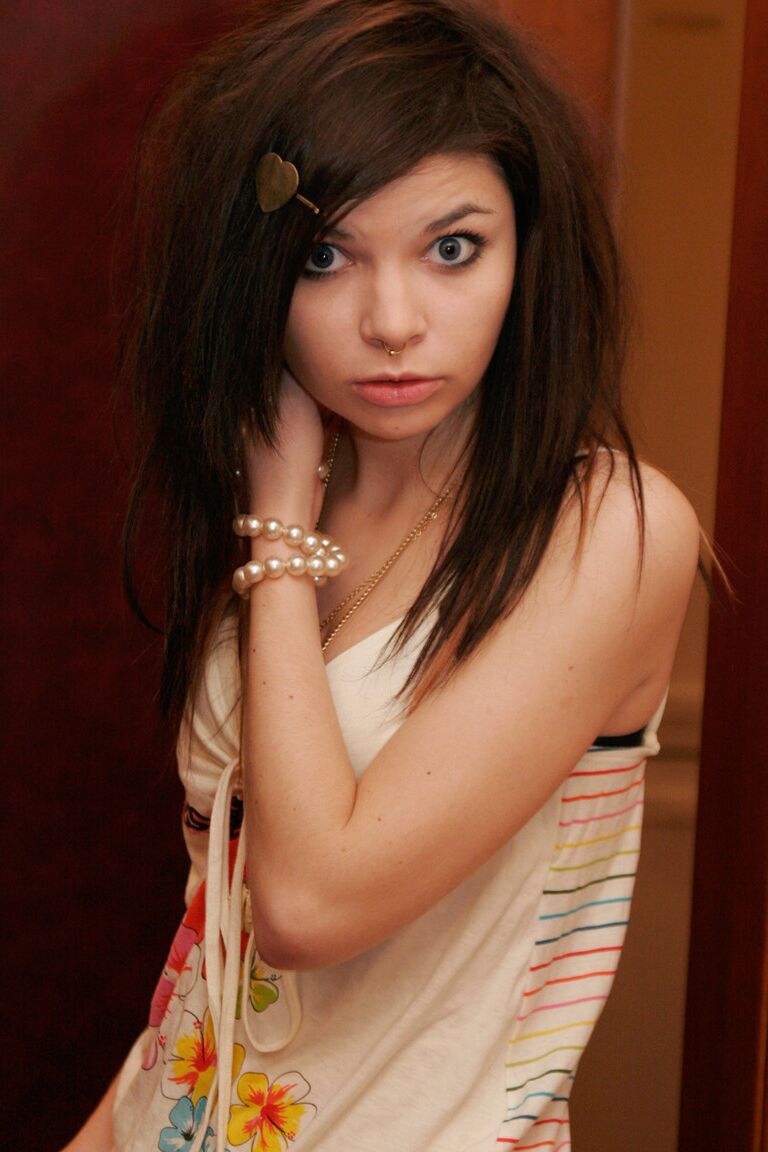 15P Cute girl Kaira 18 holds a stalk of flowers while posing clothed in a bathroom