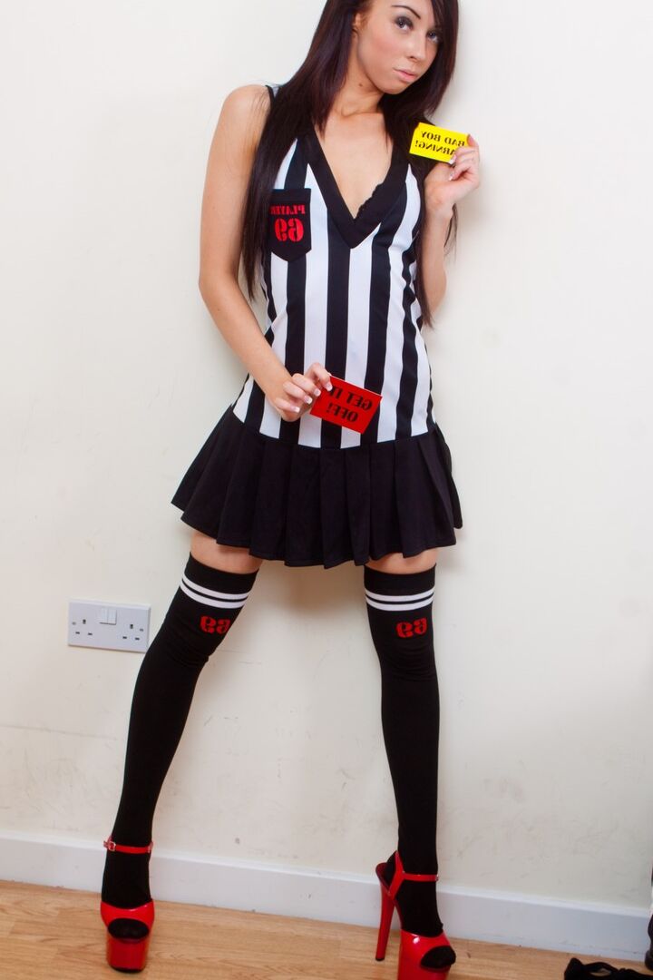 16P Lexi is a referee who is handing out red cards to the naughty football boys