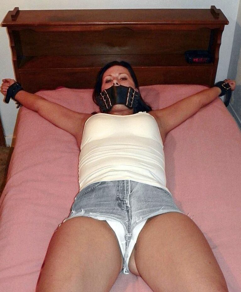 16P Solo girl is cleave gagged and hogtied on a bed in denim cutoffs