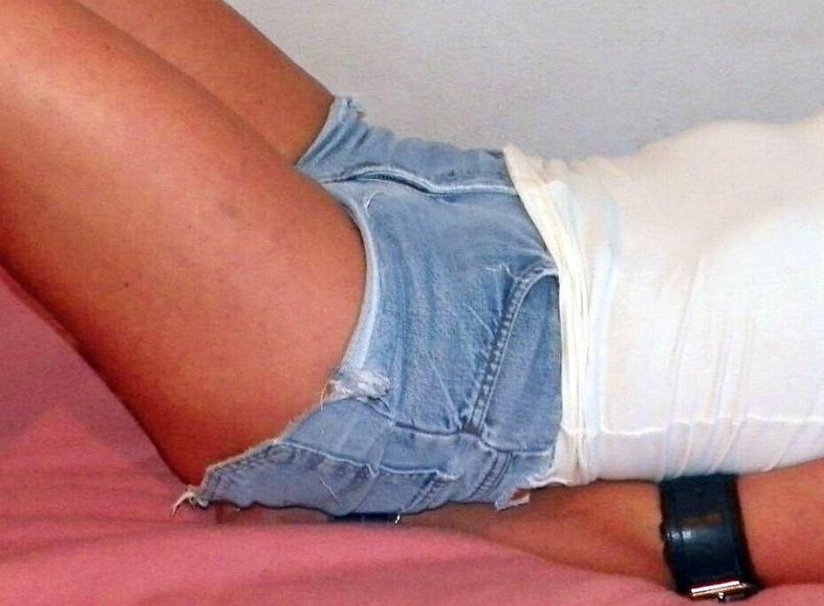 16P Solo girl is cleave gagged and hogtied on a bed in denim cutoffs