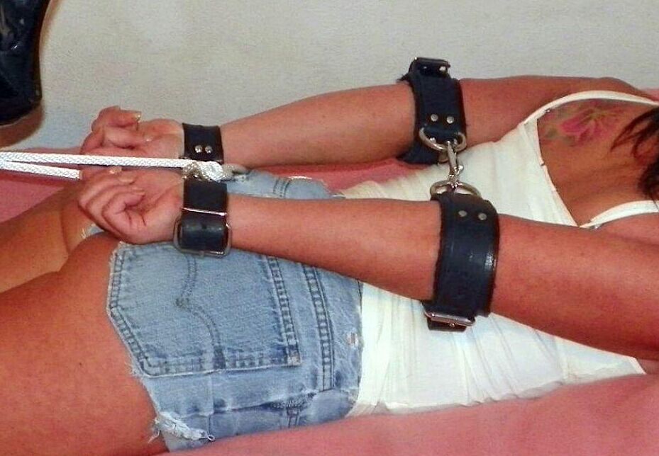 16P Solo girl is cleave gagged and hogtied on a bed in denim cutoffs