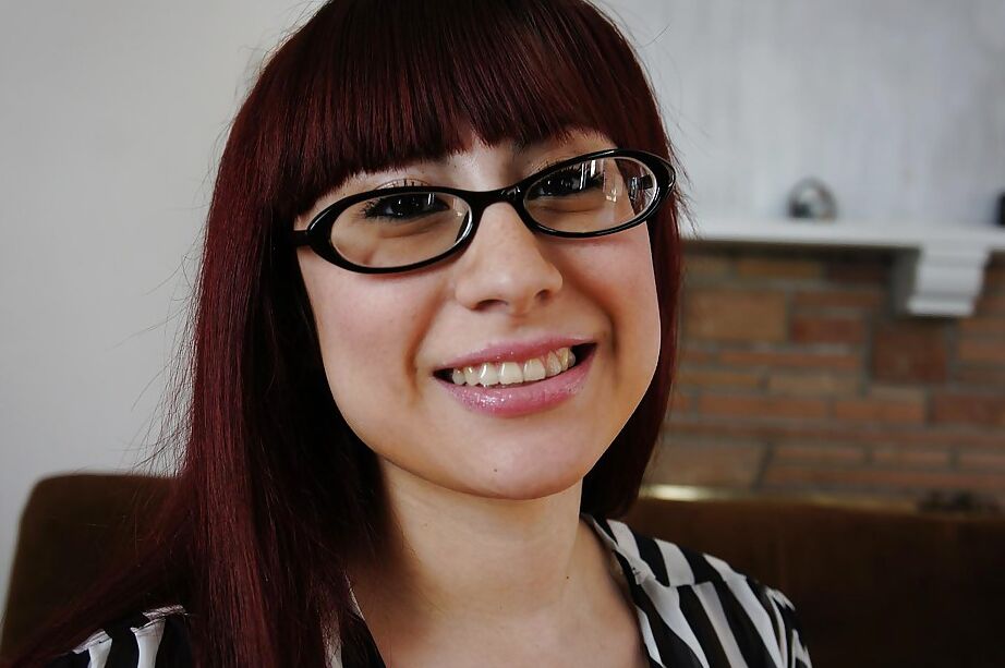 16P Perky redhead chick in glasses undressing and spreading her shaved pussy lips