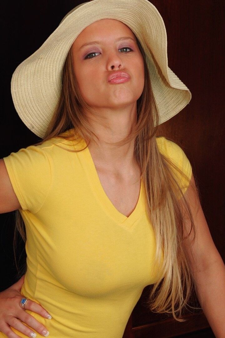 15P Curvy chick Dawson Miller purses her lips before getting naked in a sun hat