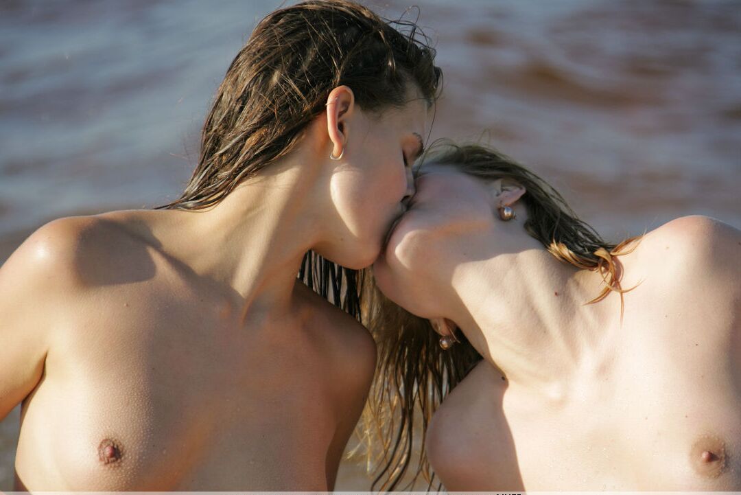 16P Naked girls share a lesbian kiss while the incoming tide washes over them
