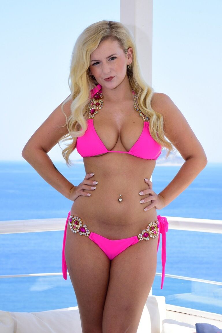 12P La jeune blonde Lycia Sharyl enlève son bikini rose pour se prélasser nue.