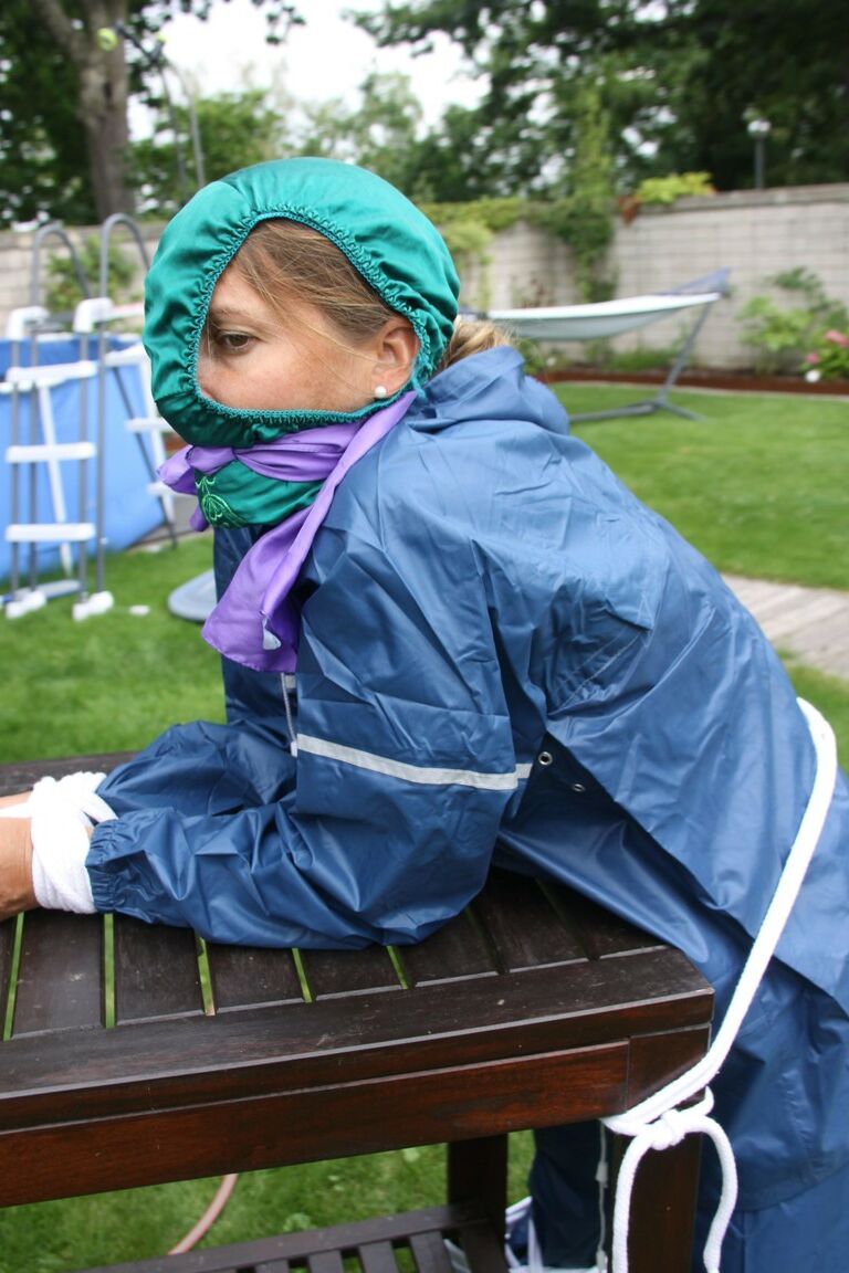 16P Caucasian woman is tied to a table in a yard with panties over her face