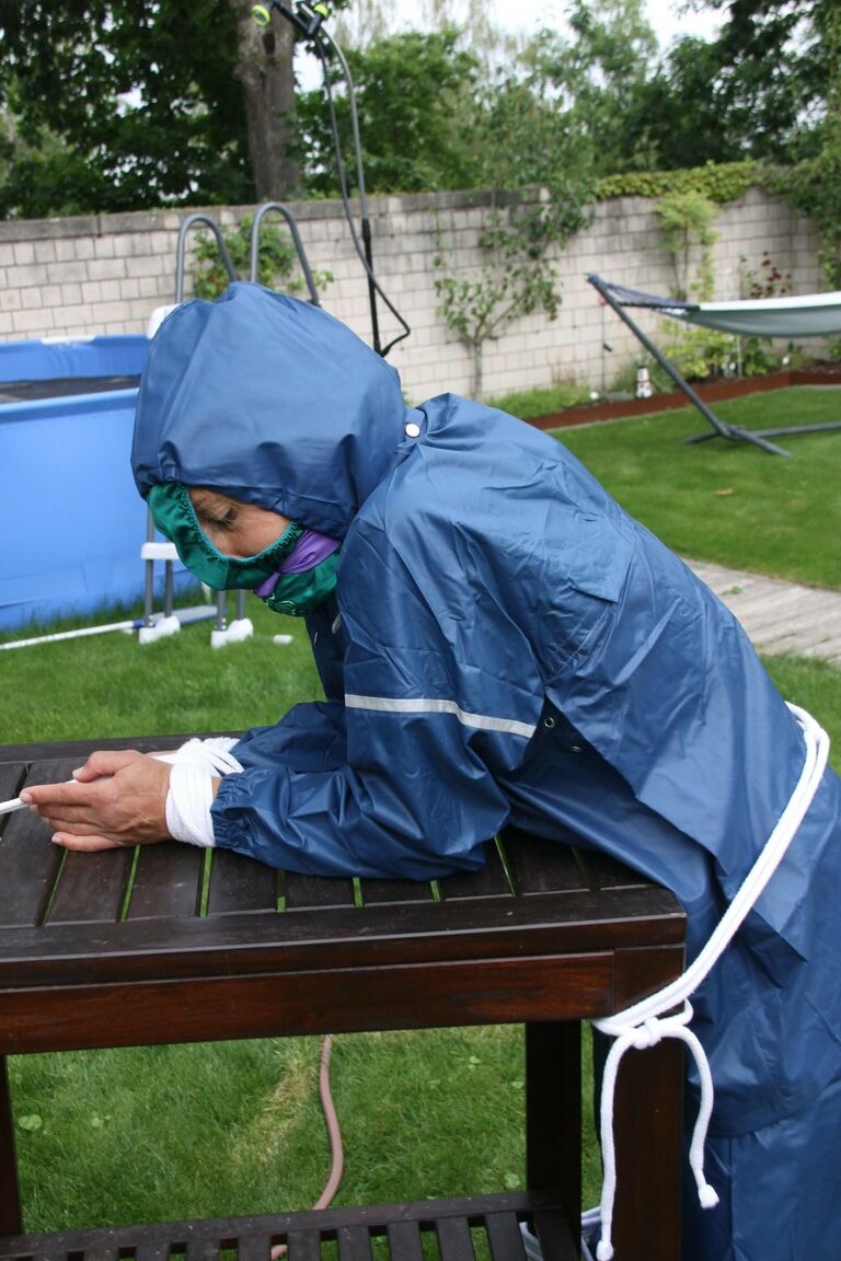 16P Caucasian woman is tied to a table in a yard with panties over her face