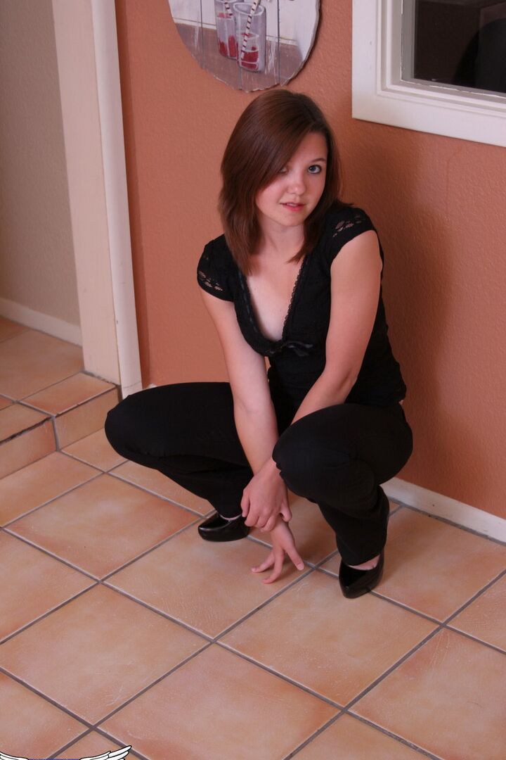 12P Redhead amateur Kir exposes her flat chest in a thong and black pumps