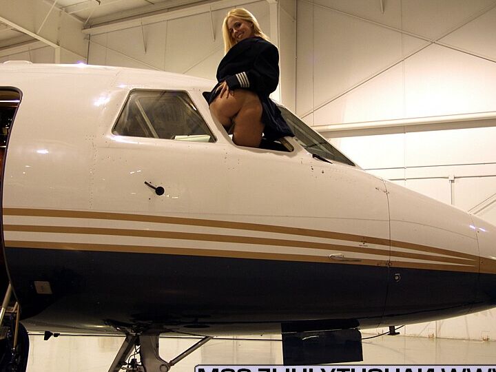 16P Blonde amateur Naughty Julie shows her tits and twat in the cockpit of a plane