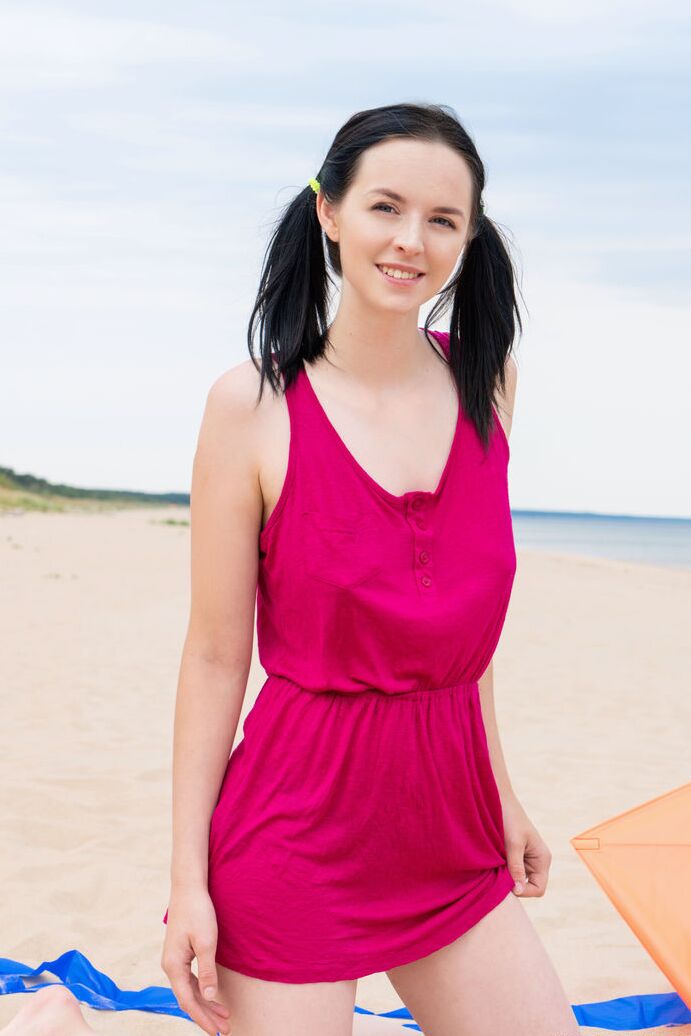 20P Dark haired amateur wears her hair in pigtails while getting nude at the beach