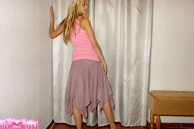 10P Clothed teen models in a skirt and tank top with curls put in her blonde hair