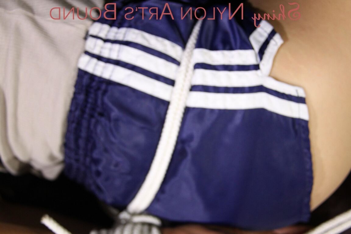 16P Sexy Sandra being tied and gagged with ropes and a cloth gag on a sofa wearing