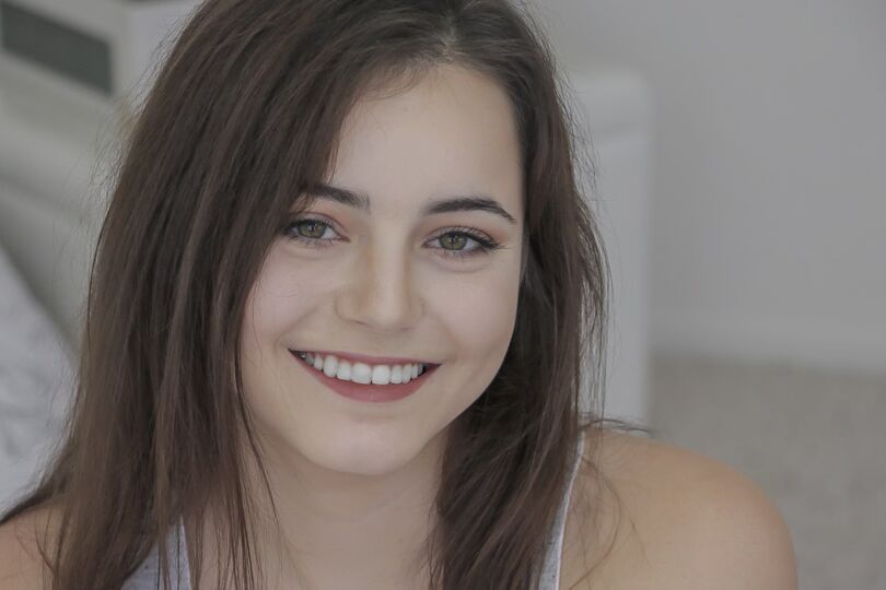 16P Smiley faced teen Kylie Quinn hanging out on her bed in red short shorts