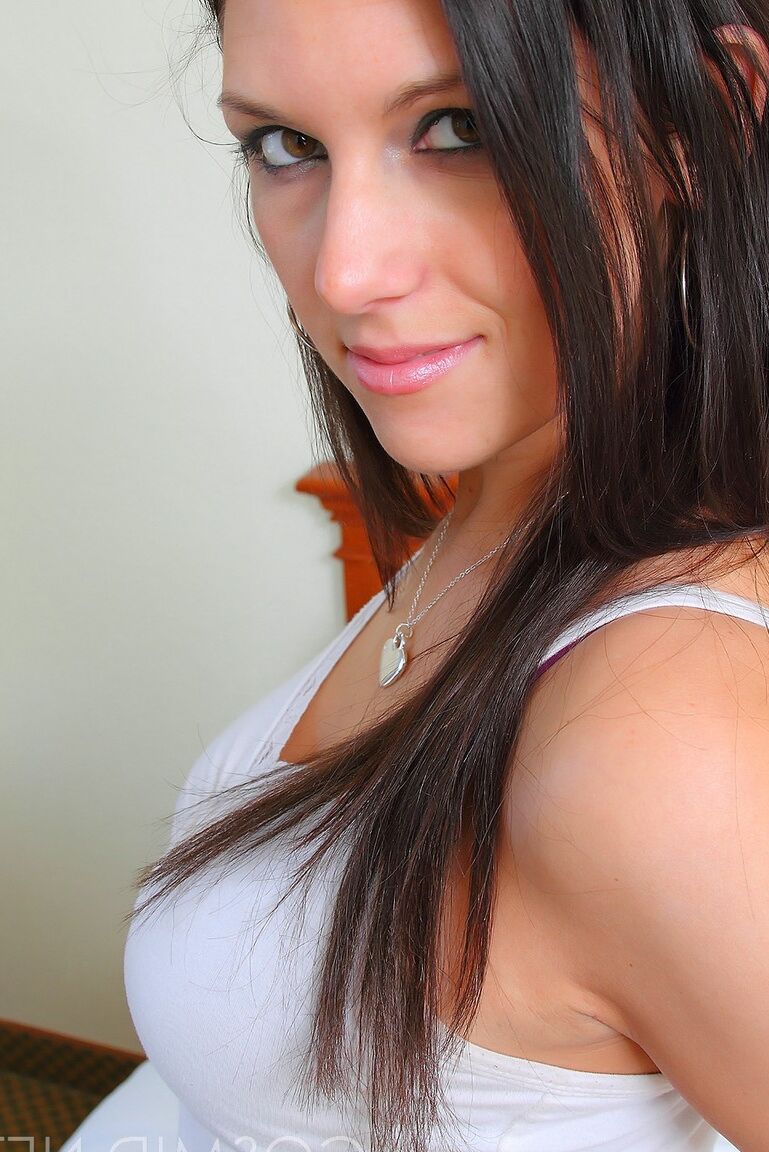 16P Brunette amateur Adrian Fletcher uncups her nice tits before removing a thong